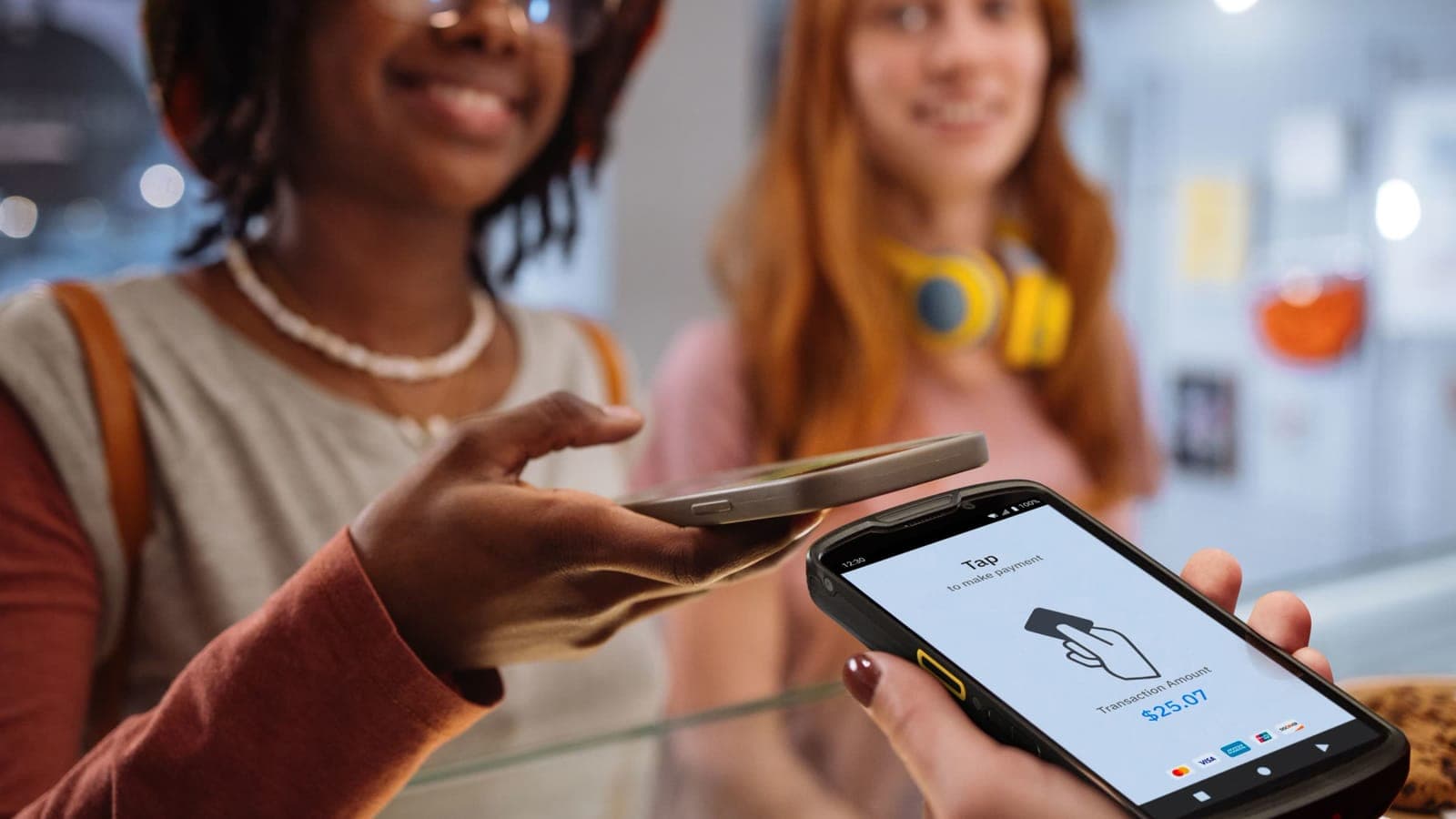 A contactless phone payment on a handheld Tap to Pay terminal